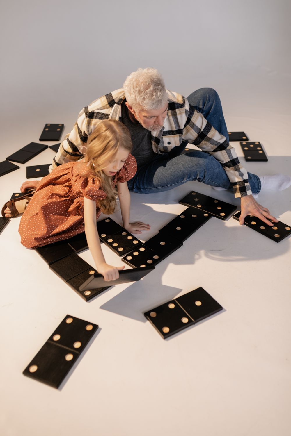 An older man and a child playing a board game together